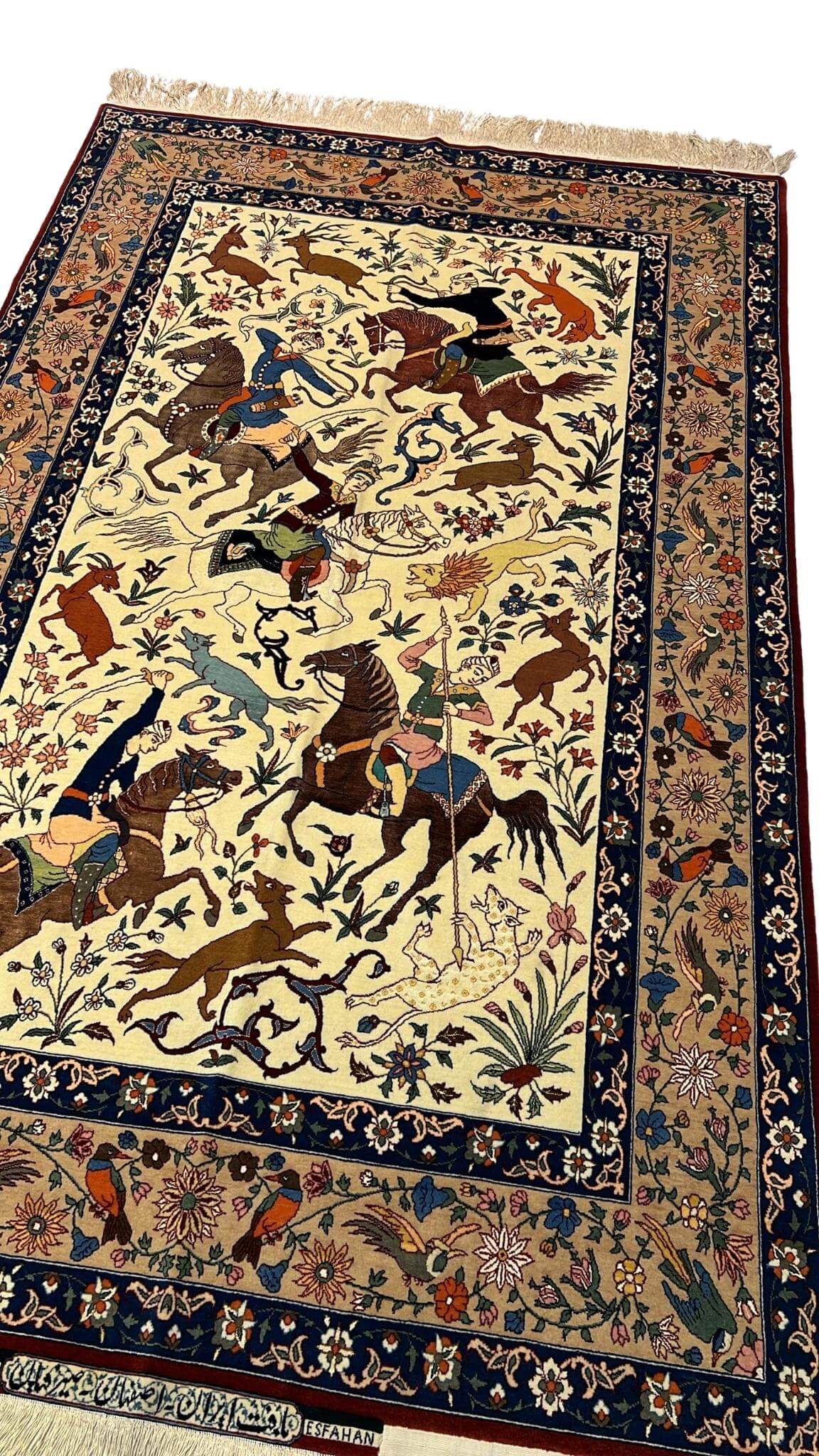 Close-up of the intricate hunting scene design on a Seirafian Persian rug, showcasing fine craftsmanship.
